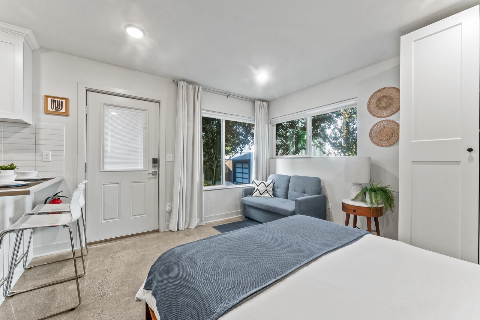 Bed and reading sofa by the corner windows